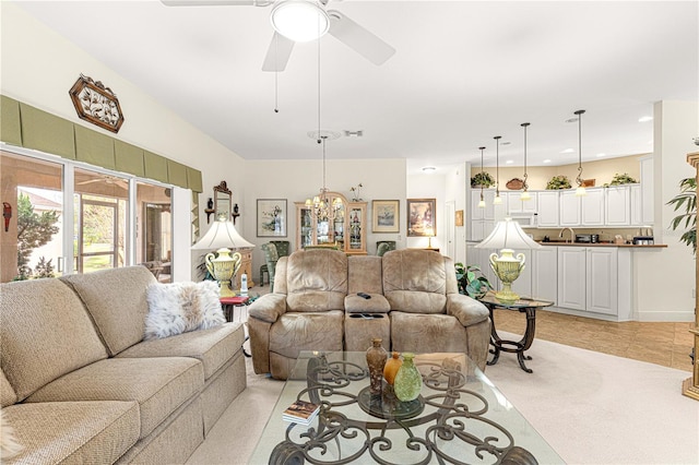 living room with ceiling fan with notable chandelier and light tile patterned flooring