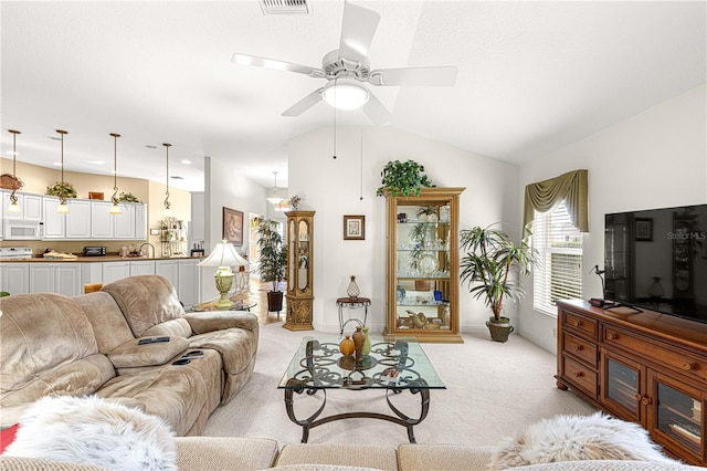 living room with light carpet, ceiling fan, lofted ceiling, and sink