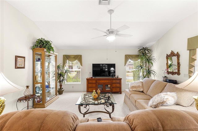 carpeted living room featuring ceiling fan, plenty of natural light, and lofted ceiling