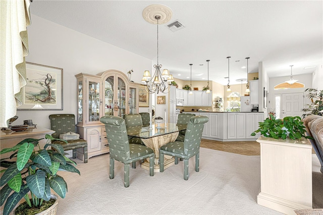 carpeted dining space featuring an inviting chandelier