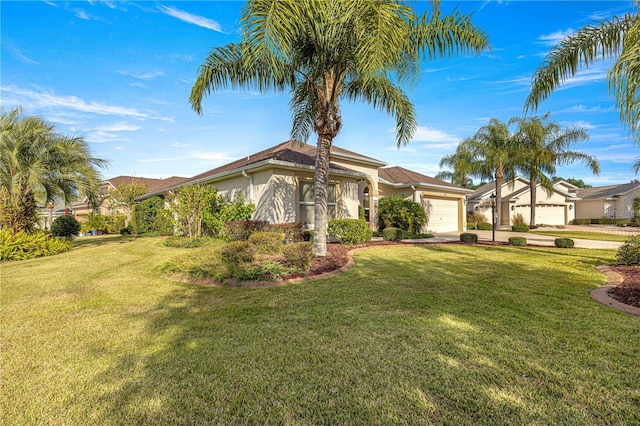 view of front of house with a front yard and a garage