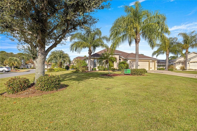 ranch-style house with a front yard and a garage