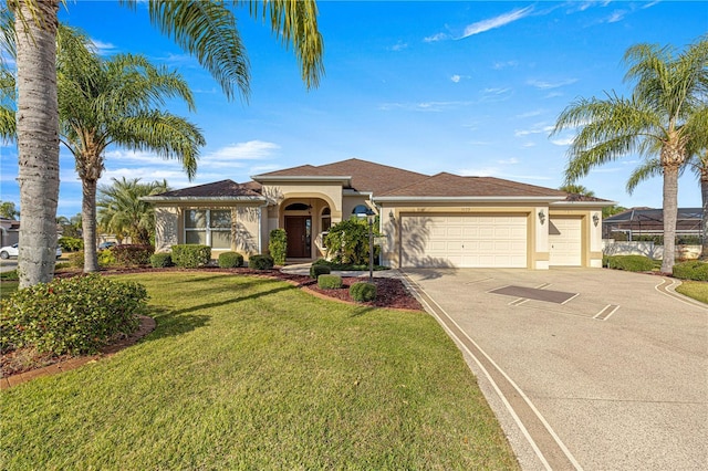 mediterranean / spanish-style house featuring a front yard and a garage