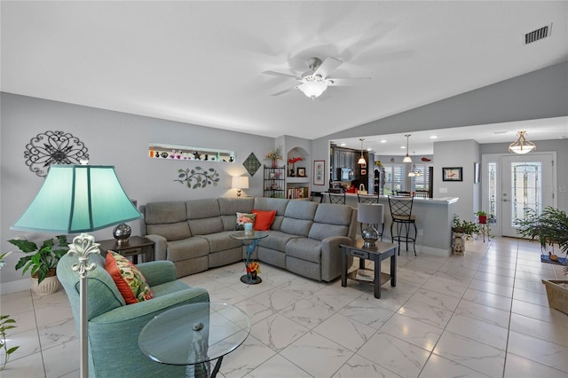 living room featuring ceiling fan and vaulted ceiling