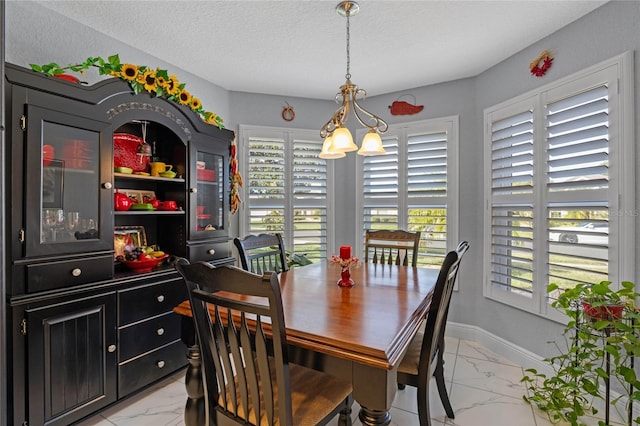 dining room featuring a textured ceiling