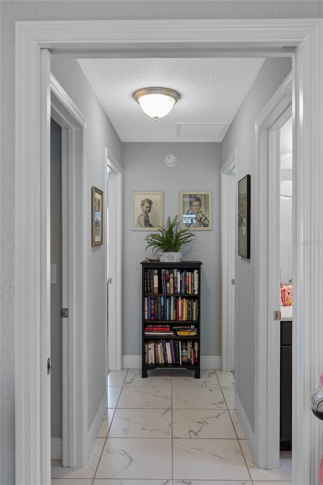 hallway featuring a textured ceiling