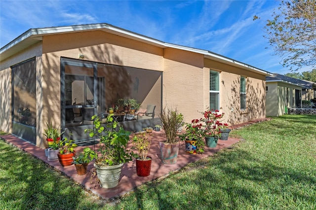 view of side of home with a yard