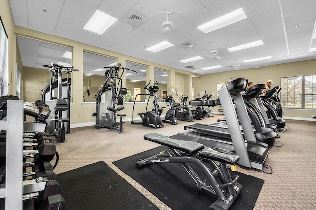 exercise room with carpet flooring and a paneled ceiling