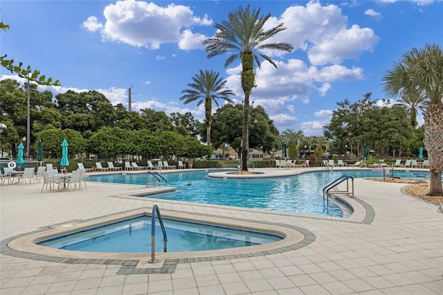 view of pool with a patio area and a hot tub