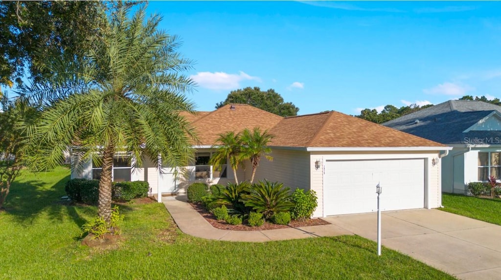 ranch-style home with a garage and a front yard