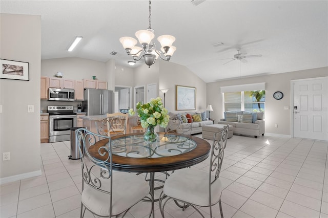 dining space featuring light tile patterned floors, vaulted ceiling, ceiling fan with notable chandelier, and visible vents