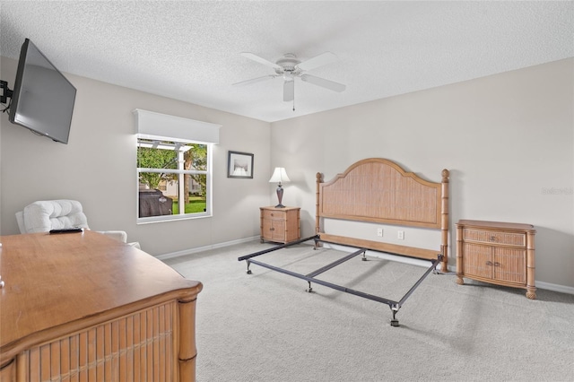 bedroom featuring a textured ceiling, baseboards, and carpet flooring