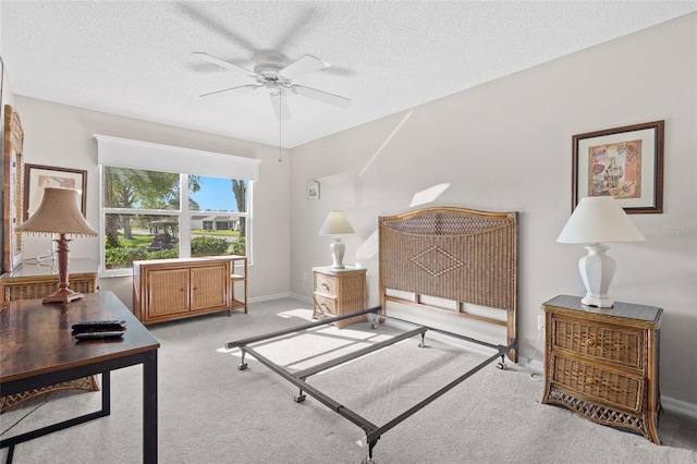 carpeted bedroom featuring baseboards and a textured ceiling