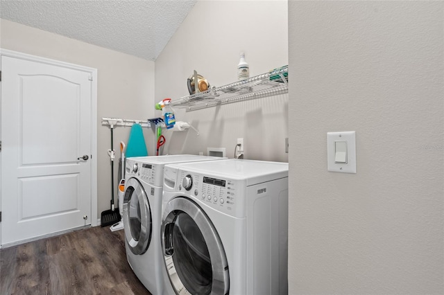 clothes washing area with a textured ceiling, laundry area, dark wood-type flooring, and independent washer and dryer