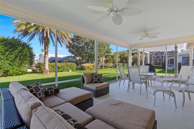 sunroom featuring a ceiling fan