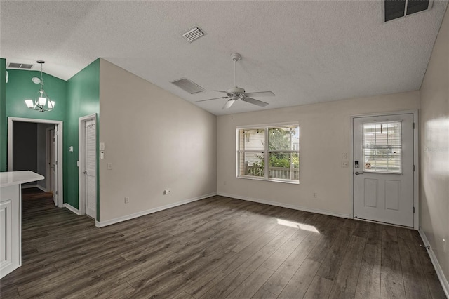 unfurnished living room with ceiling fan with notable chandelier, dark wood-type flooring, a textured ceiling, and vaulted ceiling