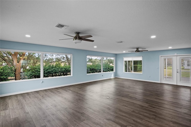 unfurnished room with ceiling fan, dark wood-type flooring, a textured ceiling, and french doors