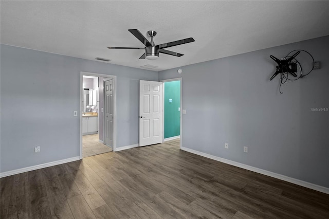 unfurnished bedroom with hardwood / wood-style floors, a textured ceiling, and ceiling fan