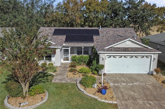 view of front of property with a front lawn and solar panels