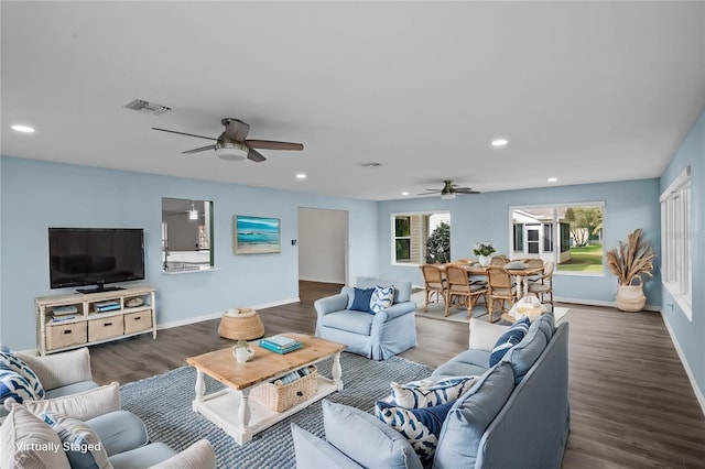 living room with ceiling fan and dark hardwood / wood-style floors