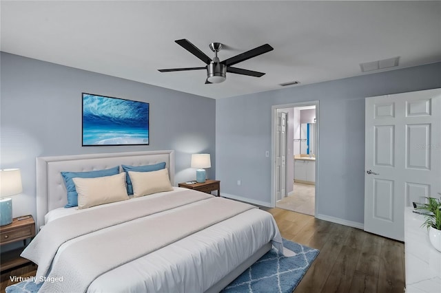 bedroom with dark hardwood / wood-style floors, ceiling fan, and ensuite bathroom