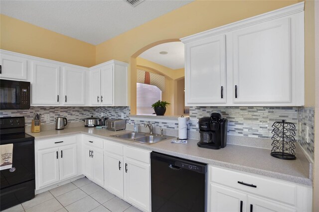 kitchen featuring black appliances, decorative backsplash, white cabinetry, and sink