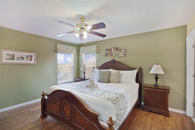 bedroom with hardwood / wood-style floors and ceiling fan