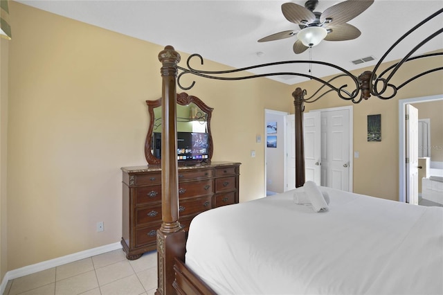 bedroom featuring ensuite bath, ceiling fan, and light tile patterned floors