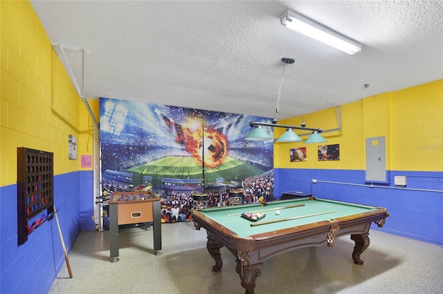 game room with electric panel, a textured ceiling, and billiards