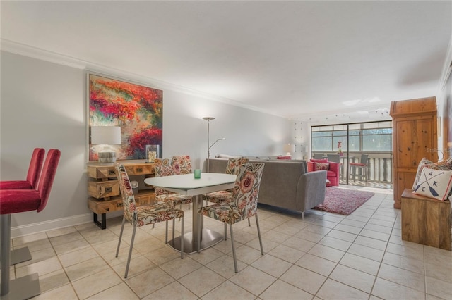 tiled dining area featuring crown molding