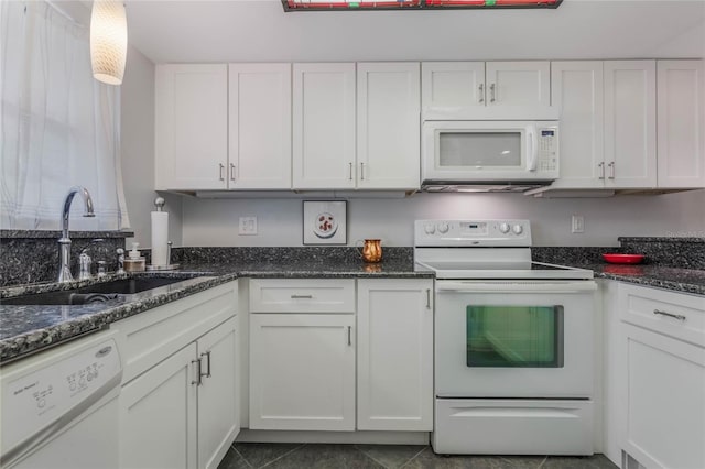 kitchen with white cabinets, white appliances, dark stone counters, and sink