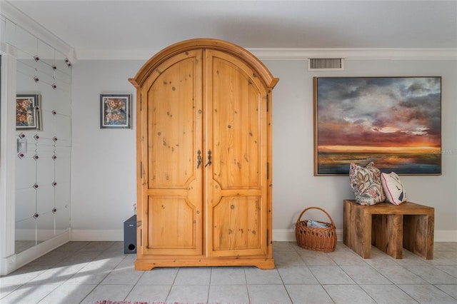 tiled foyer entrance with ornamental molding