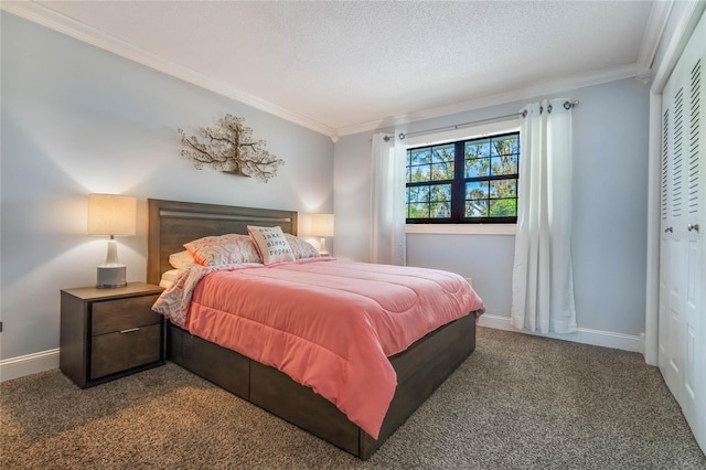 bedroom with a closet, ornamental molding, a textured ceiling, and dark colored carpet