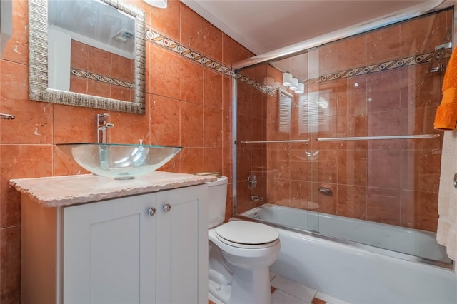 full bathroom with decorative backsplash, bath / shower combo with glass door, vanity, tile walls, and toilet