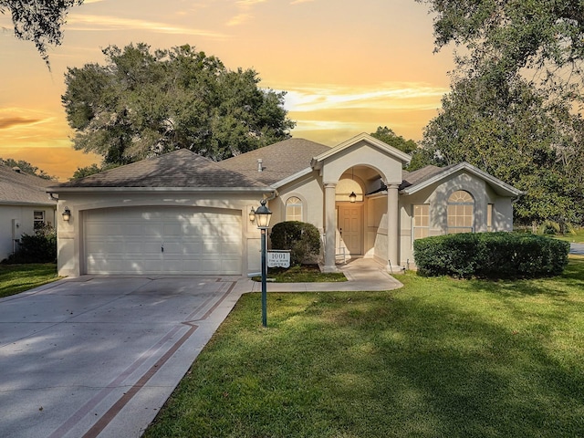 ranch-style home with a lawn and a garage