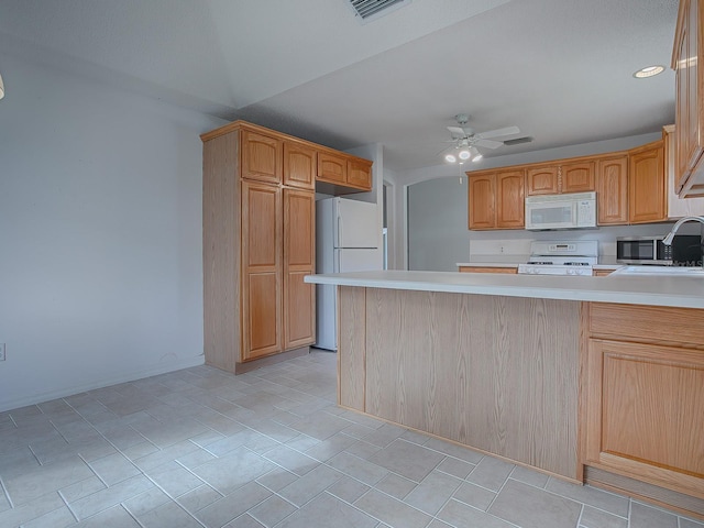 kitchen with kitchen peninsula, ceiling fan, white appliances, and sink