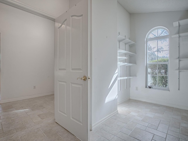 staircase featuring a textured ceiling and vaulted ceiling