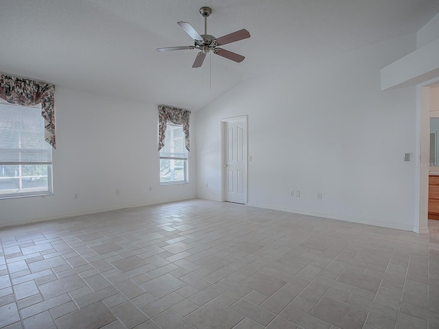 empty room featuring vaulted ceiling and ceiling fan