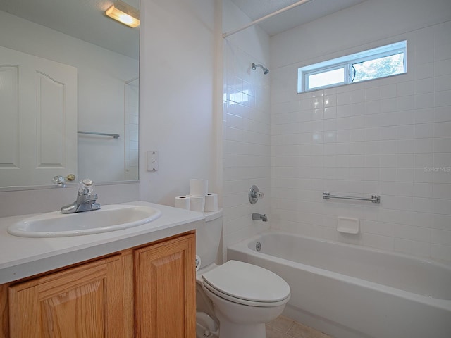 full bathroom with tile patterned flooring, vanity, toilet, and tiled shower / bath