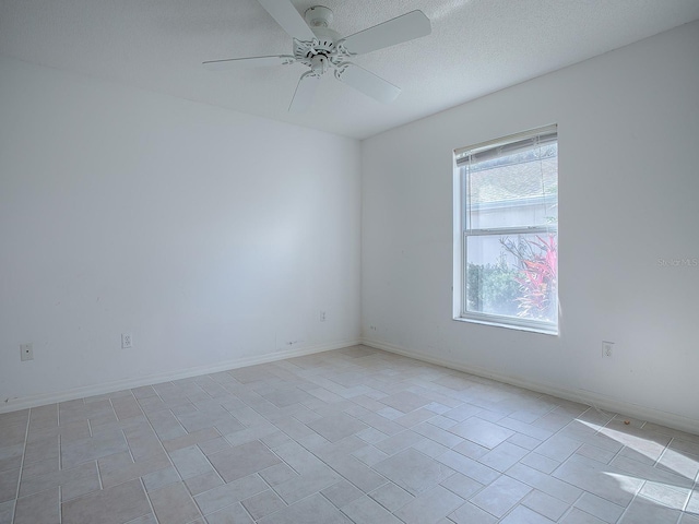 spare room with ceiling fan and a textured ceiling