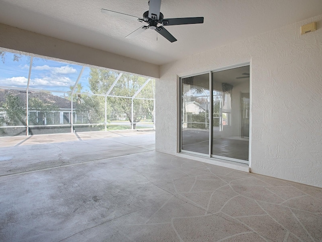 view of patio / terrace with ceiling fan and a lanai