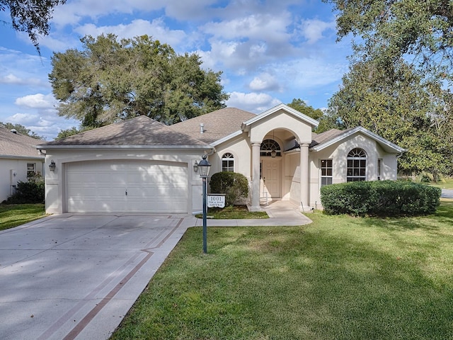 single story home with a garage and a front lawn