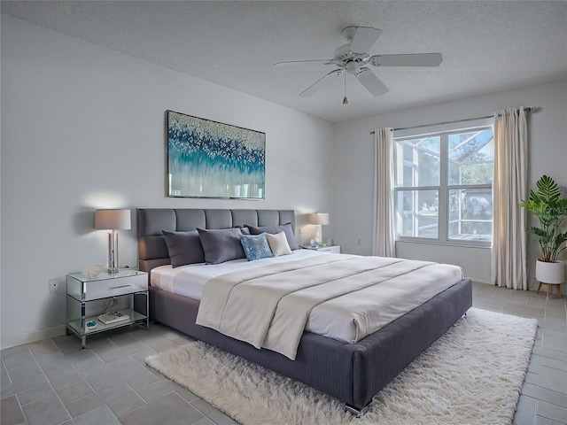 bedroom with a textured ceiling and ceiling fan