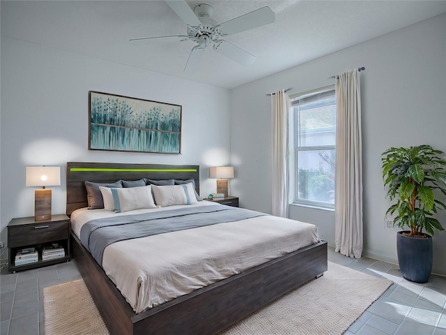 bedroom featuring ceiling fan and light tile patterned flooring