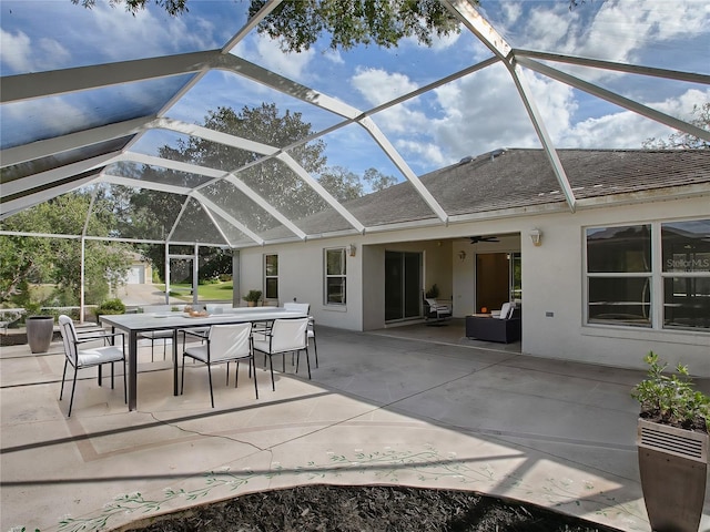 view of patio / terrace featuring outdoor lounge area, ceiling fan, and glass enclosure