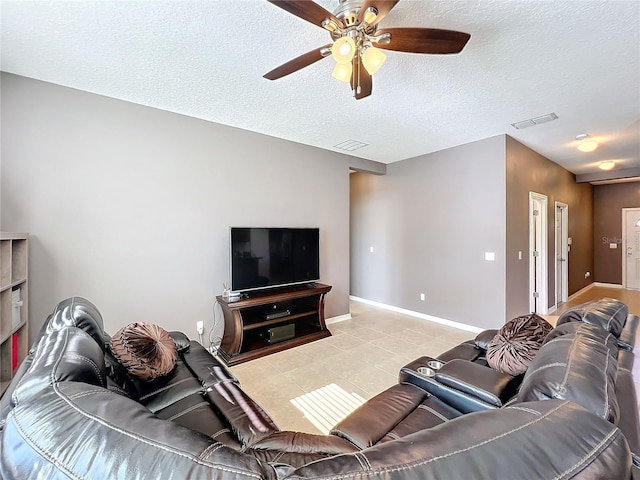 living room featuring visible vents, a textured ceiling, baseboards, and light tile patterned flooring