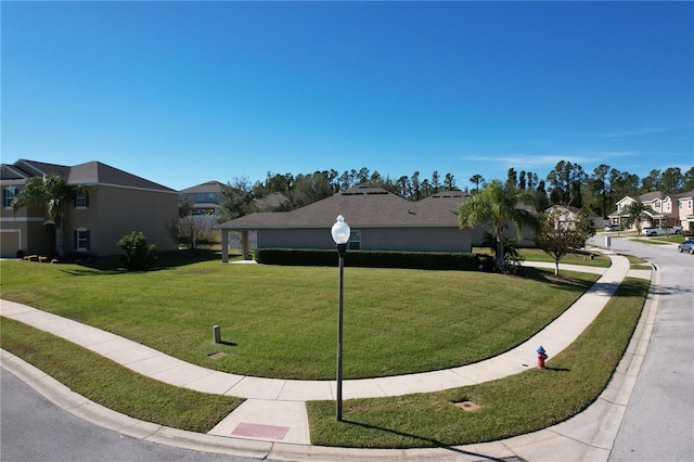 surrounding community featuring a lawn and a residential view