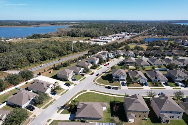 drone / aerial view featuring a water view and a residential view