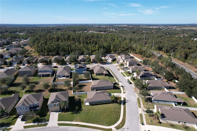 birds eye view of property featuring a forest view and a residential view