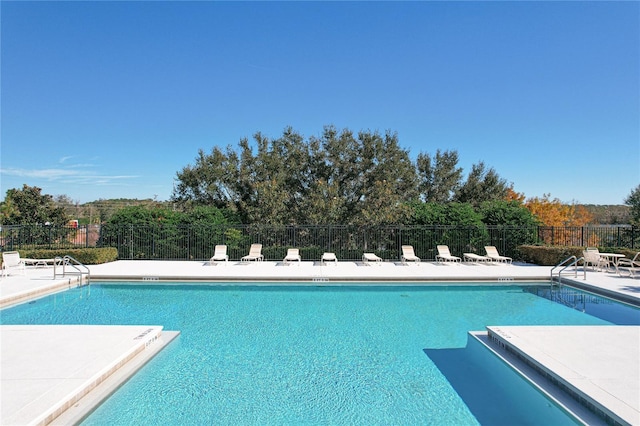 pool featuring fence and a patio